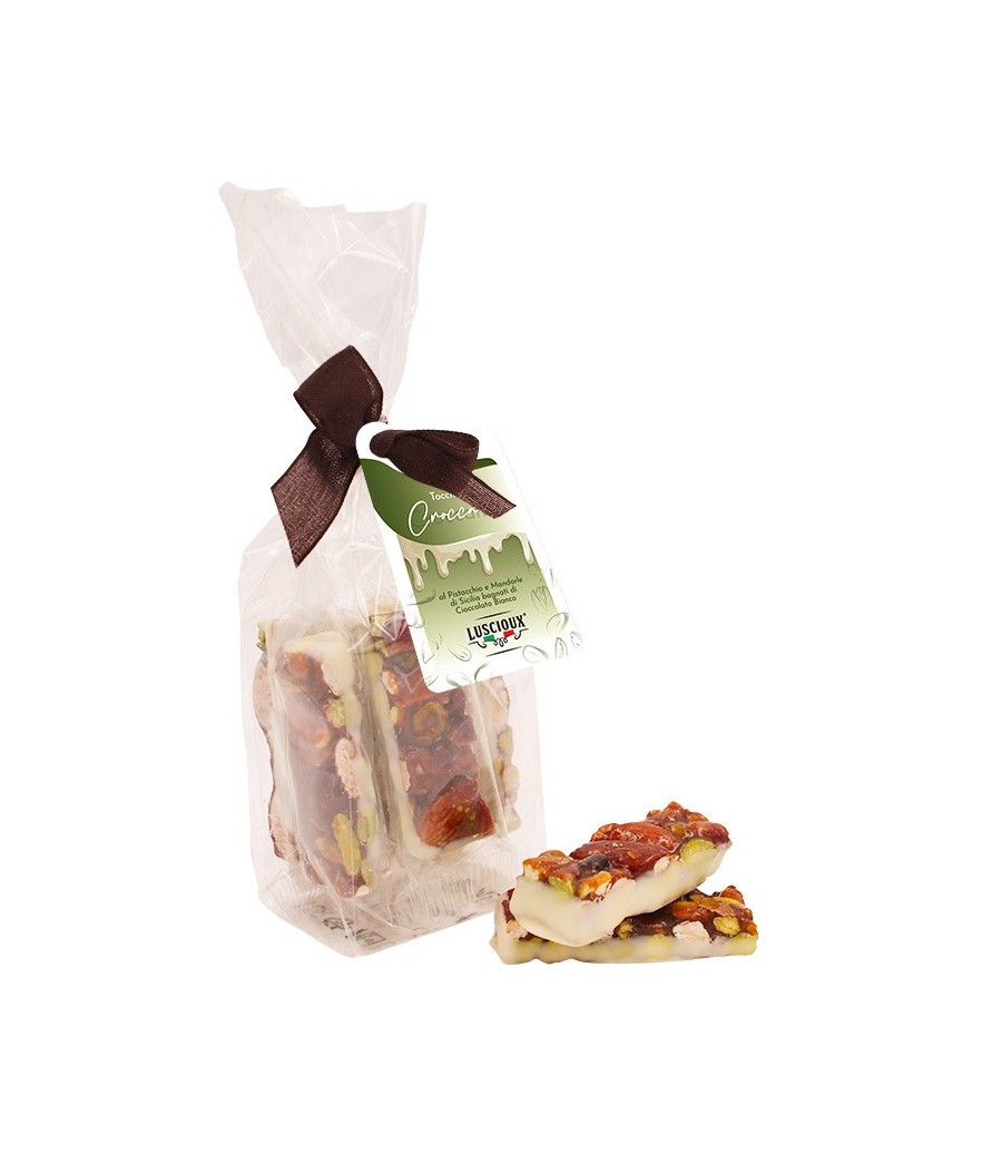 Luscioux Morceaux de croquant dans un sac avec nœud de pistache et amande sicilienne trempée dans du chocolat blanc